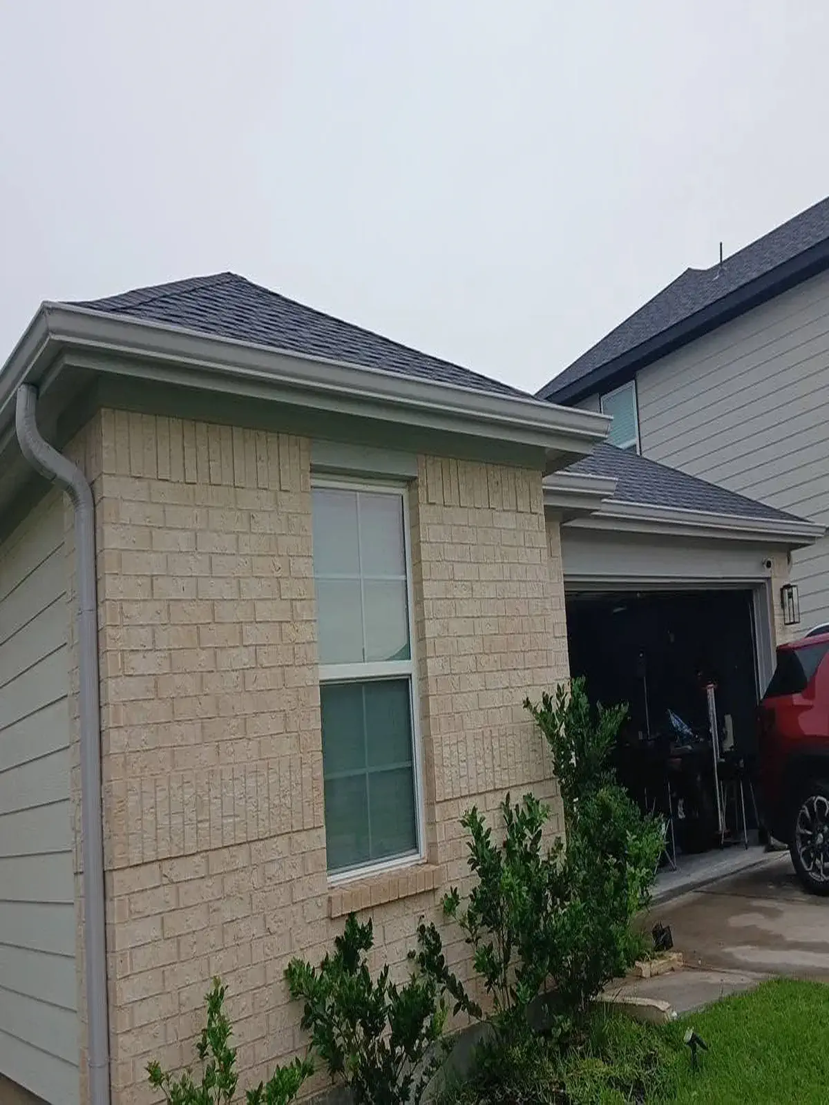 Gray gutters installation on a newly built house