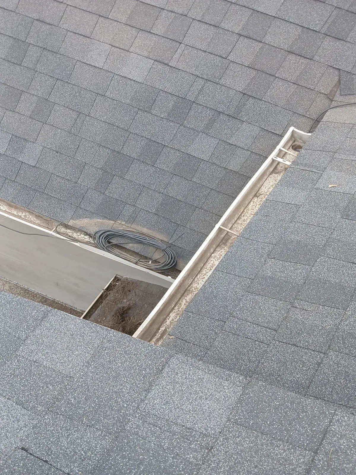 Gutter cleaning on a residential roofline