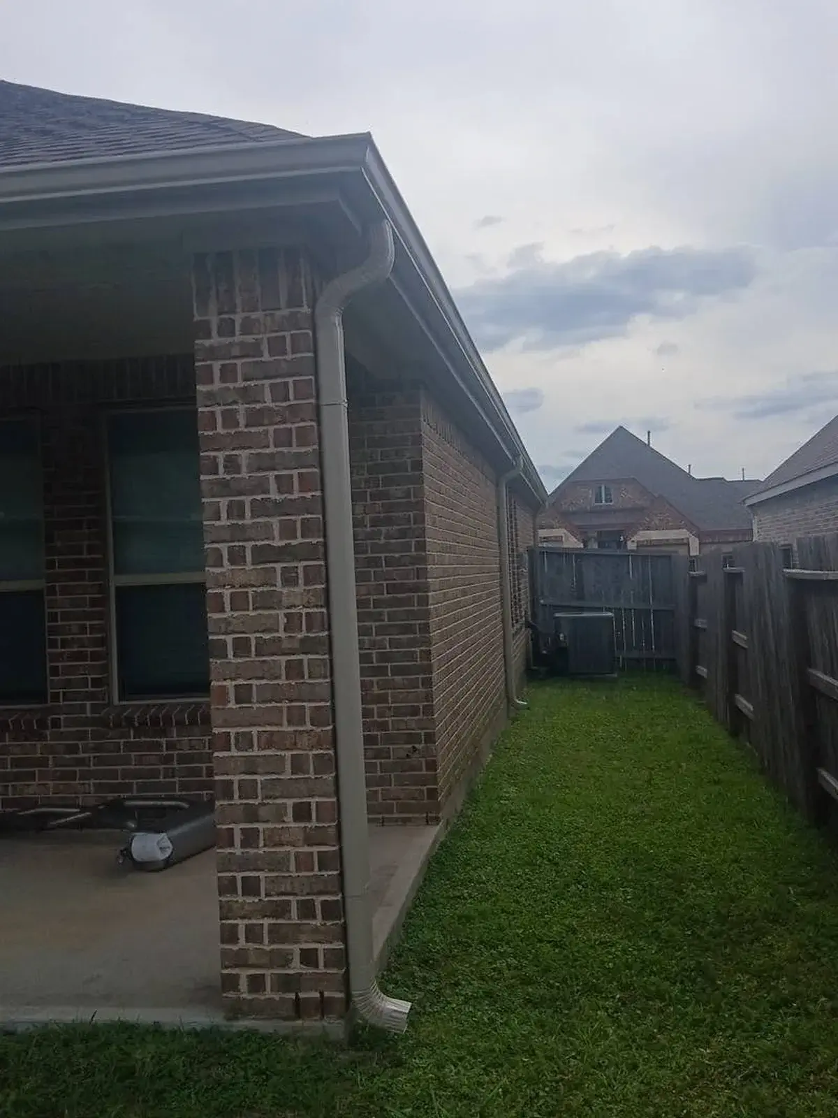 White downspout replacement on the side of a home